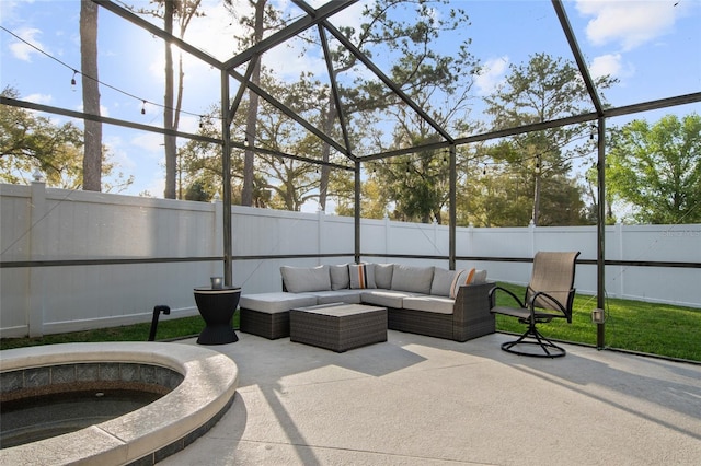 view of patio / terrace featuring glass enclosure, a fenced backyard, and an outdoor hangout area