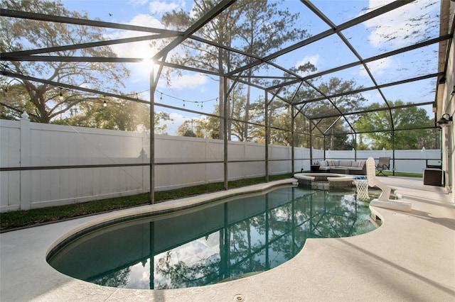 view of swimming pool featuring a lanai, a fenced backyard, a pool with connected hot tub, and a patio