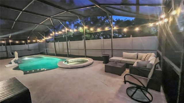 view of swimming pool with a fenced backyard, glass enclosure, and a patio