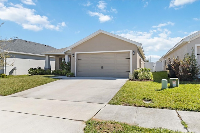 view of front of home featuring a front yard, a garage, driveway, and stucco siding