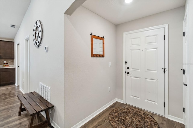 entrance foyer featuring wood finished floors, visible vents, and baseboards