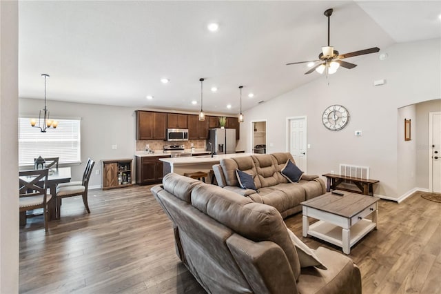 living room featuring recessed lighting, visible vents, light wood-style flooring, and ceiling fan with notable chandelier