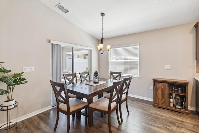 dining space with baseboards, visible vents, an inviting chandelier, dark wood-style flooring, and vaulted ceiling