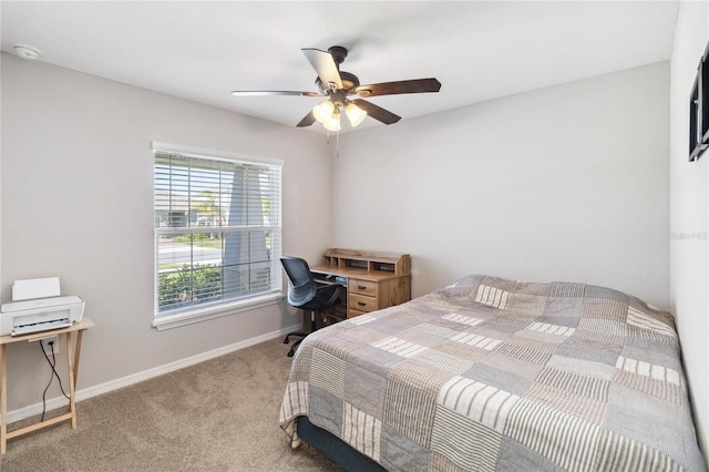 carpeted bedroom with a ceiling fan and baseboards