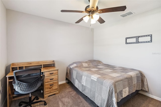 bedroom featuring visible vents, baseboards, a ceiling fan, and dark carpet