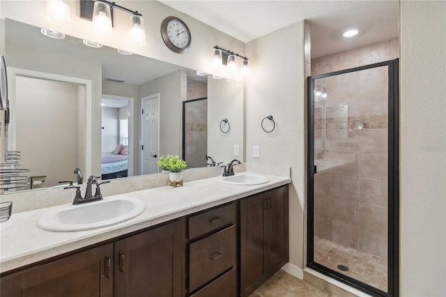 ensuite bathroom with ensuite bath, a shower stall, double vanity, and a sink