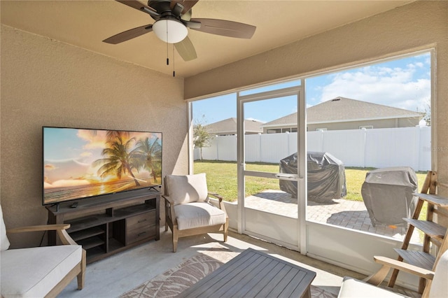 sunroom featuring a ceiling fan