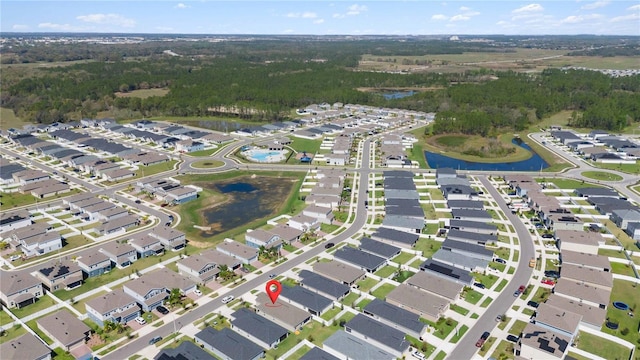 drone / aerial view featuring a residential view and a water view