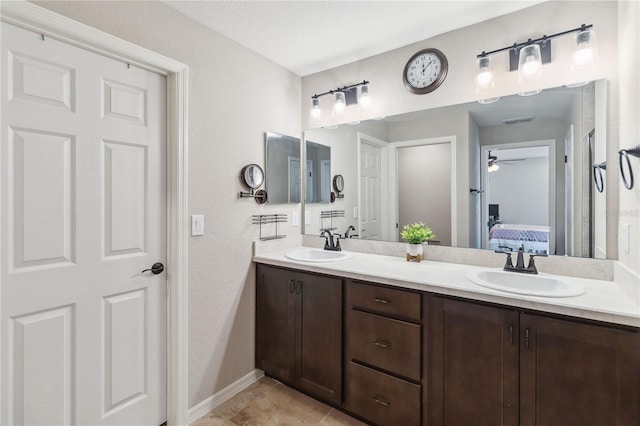 1575 Eucalyptus Way, Davenport, FL 33837 - ensuite bathroom featuring double vanity, a ceiling fan, and tile patterned flooring
