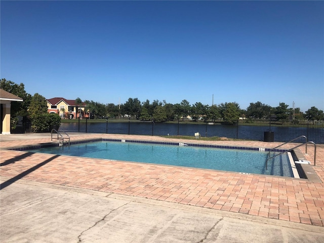 community pool featuring a patio area and fence