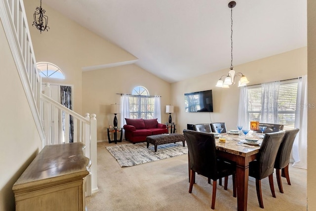 dining room featuring light carpet, high vaulted ceiling, stairway, and a notable chandelier