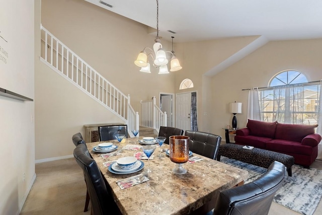 dining area with baseboards, a chandelier, light colored carpet, stairway, and high vaulted ceiling