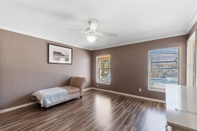 unfurnished room featuring dark wood-style floors, a textured ceiling, baseboards, and crown molding