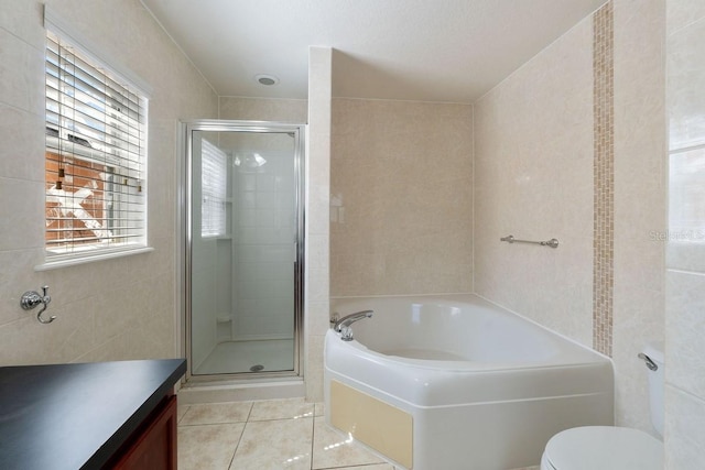 full bath with toilet, tile walls, a shower stall, a bath, and tile patterned floors