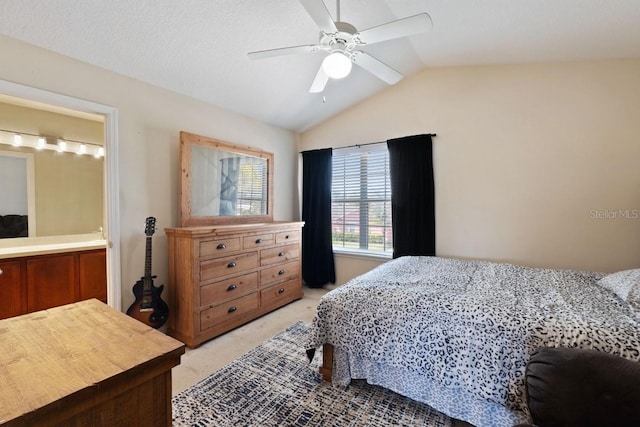 bedroom featuring a ceiling fan, lofted ceiling, and light colored carpet