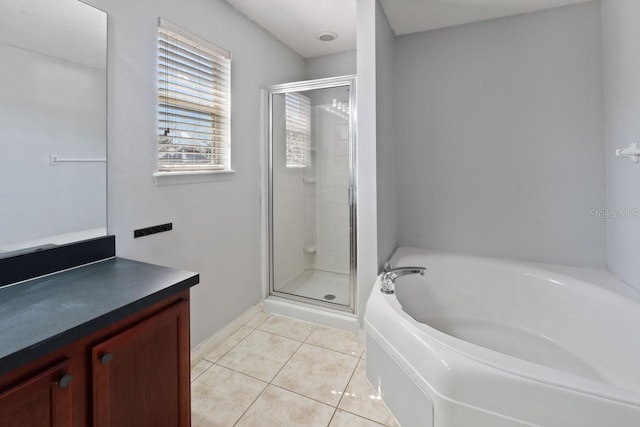 bathroom featuring vanity, tile patterned flooring, a bath, and a shower stall