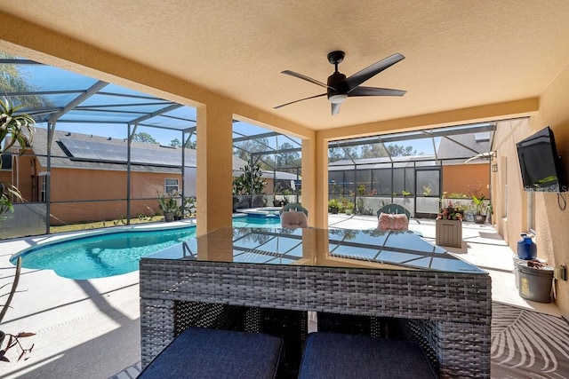 view of pool featuring glass enclosure and a patio