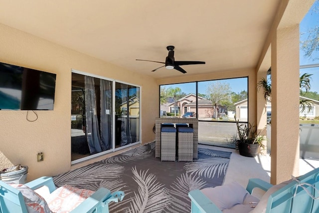 sunroom / solarium with a ceiling fan