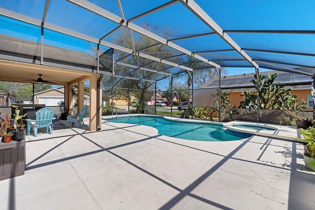 view of pool with ceiling fan, a patio, a pool with connected hot tub, and glass enclosure