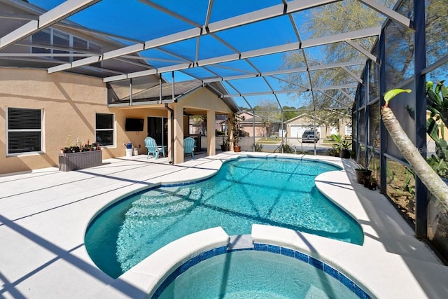 view of pool with glass enclosure, a patio area, and a pool with connected hot tub