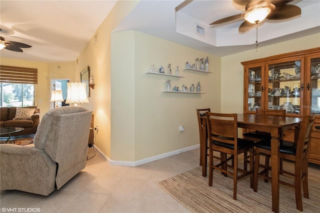 dining area with light tile patterned floors, baseboards, visible vents, and a ceiling fan