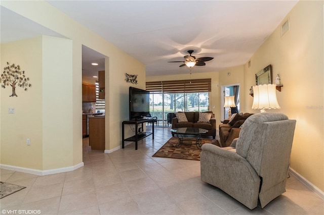 living area with ceiling fan, light tile patterned floors, visible vents, and baseboards