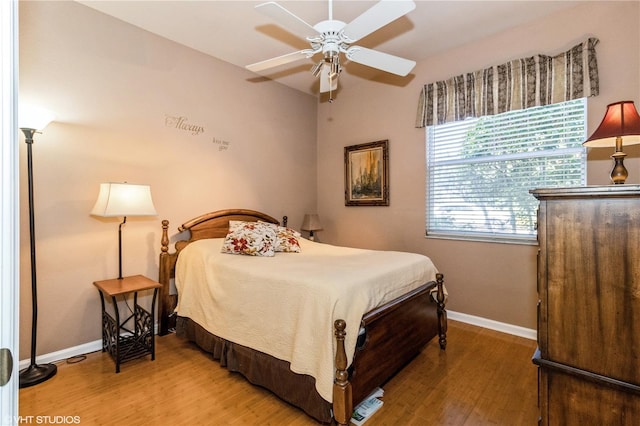 bedroom featuring light wood-type flooring, ceiling fan, and baseboards