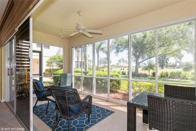 sunroom / solarium with a ceiling fan