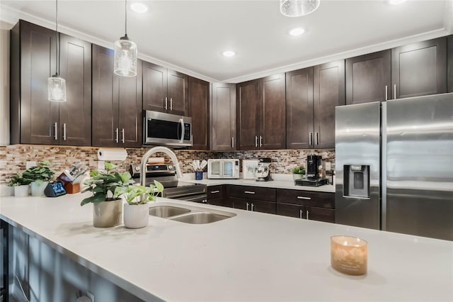 kitchen with decorative backsplash, appliances with stainless steel finishes, light countertops, and dark brown cabinets