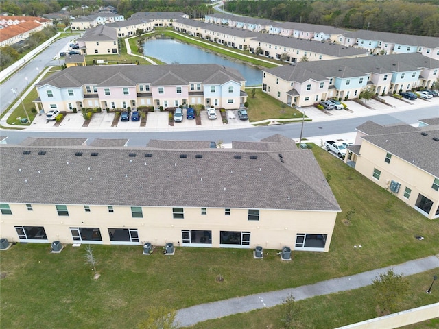 birds eye view of property featuring a water view and a residential view