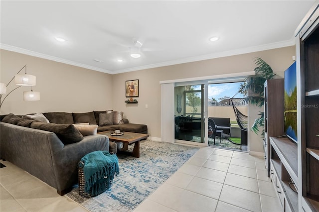 living room featuring light tile patterned floors, ceiling fan, baseboards, and crown molding