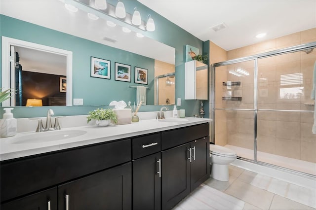 full bath featuring double vanity, a stall shower, a sink, and tile patterned floors