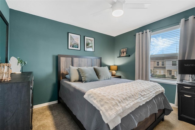 bedroom featuring light carpet, ceiling fan, and baseboards