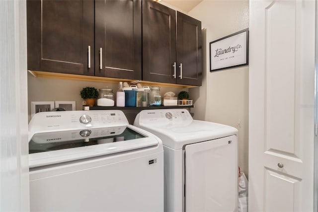 laundry room featuring cabinet space and washer and clothes dryer