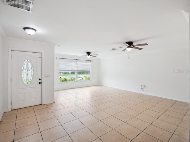 foyer entrance featuring visible vents, ornamental molding, a ceiling fan, and light tile patterned flooring