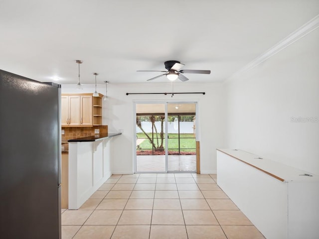 kitchen with light tile patterned floors, open shelves, tasteful backsplash, dark countertops, and crown molding