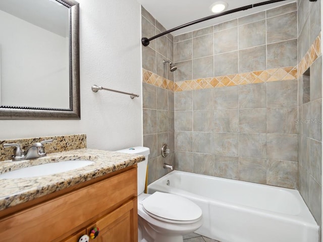 bathroom with vanity, bathtub / shower combination, and toilet