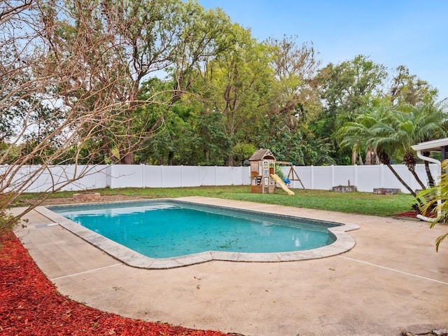 view of pool with a patio, a playground, a fenced backyard, a lawn, and a fenced in pool