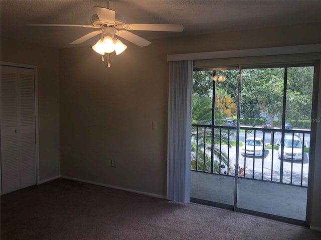 interior space with baseboards, a ceiling fan, access to outside, carpet flooring, and a closet