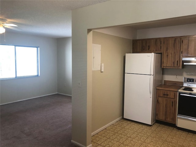 kitchen featuring electric stove, freestanding refrigerator, a textured ceiling, baseboards, and exhaust hood