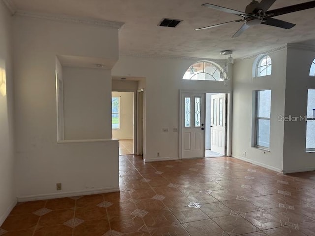 foyer with a ceiling fan, a healthy amount of sunlight, visible vents, and baseboards