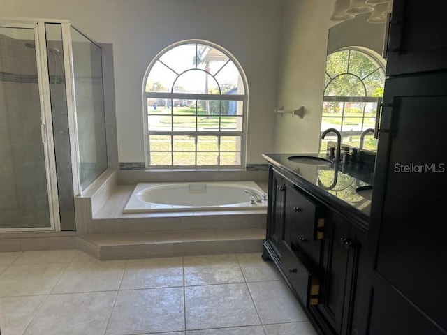 full bath with a garden tub, a shower stall, vanity, and tile patterned floors