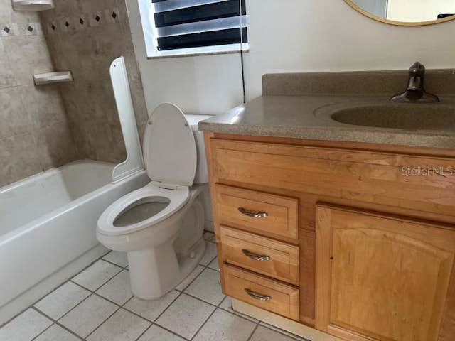 bathroom featuring toilet, vanity, and tile patterned floors