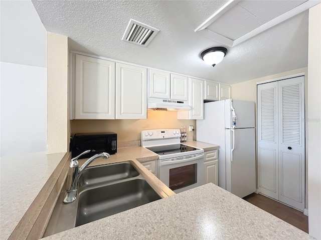 562 Orange Dr Unit 33, Altamonte Springs, FL 32701 - kitchen with visible vents, a sink, under cabinet range hood, white appliances, and light countertops