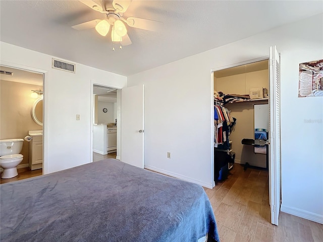 562 Orange Dr Unit 33, Altamonte Springs, FL 32701 - bedroom featuring wood finished floors, visible vents, a closet, a walk in closet, and connected bathroom