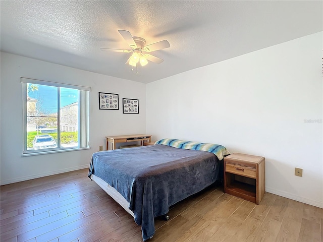 562 Orange Dr Unit 33, Altamonte Springs, FL 32701 - bedroom featuring light wood finished floors, a textured ceiling, and baseboards