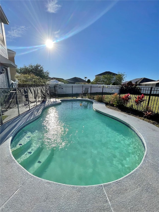 view of pool with a fenced in pool and fence