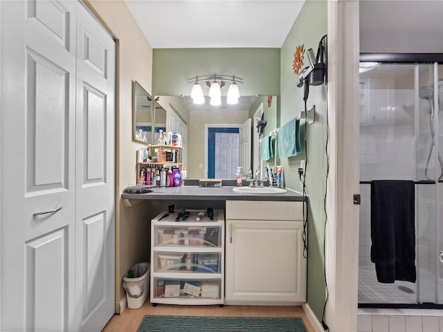 bathroom with a stall shower and vanity