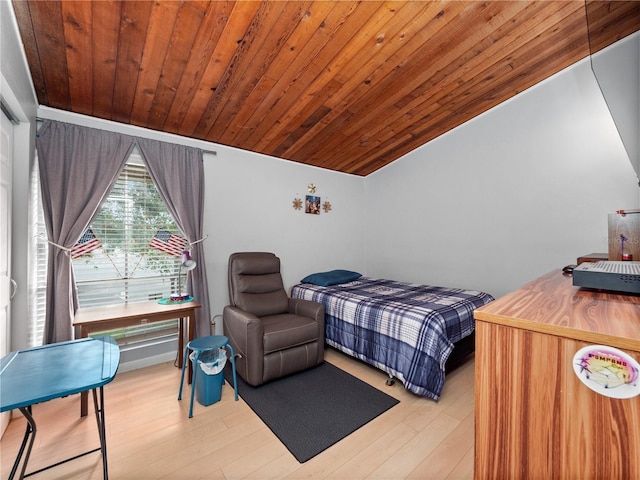 bedroom featuring vaulted ceiling, wooden ceiling, and wood finished floors