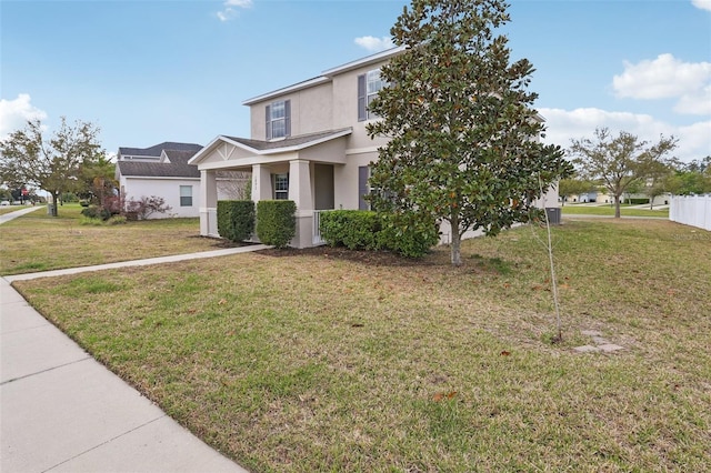 view of front of house with a front yard and stucco siding